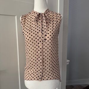 Light pink and black polka dot sheer sleeveless blouse with bow detail